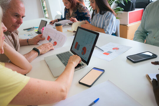 Diverse team analyzing financial data in bright office