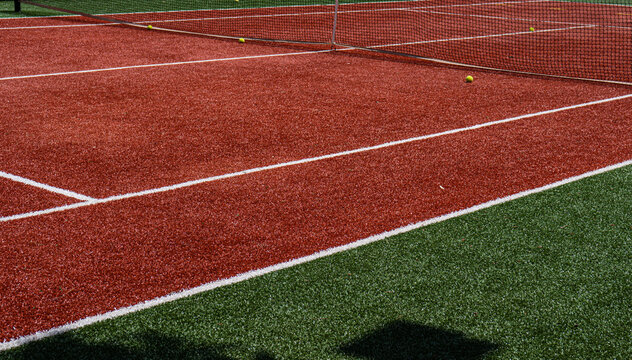 Close-up view of a red and green tennis court with details