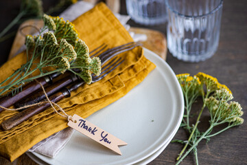 Rustic summer table setting with fresh meadow wildflowers