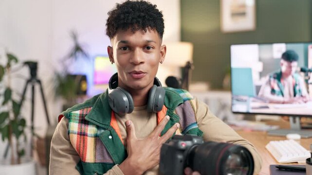 Camera, content creator and man in home for promotion or marketing with product at home. Talking, face and influencer live streaming with dslr equipment review or feedback for advertising on internet