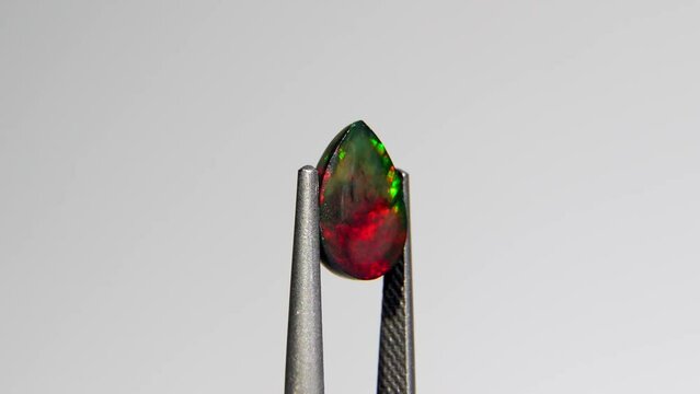 natural rainbow opal gem on the background