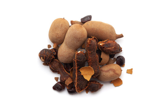 Top view of a pile of Fresh Organic Sweet Tamarind (Tamarindus indica) Fruit, isolated on a white background.
