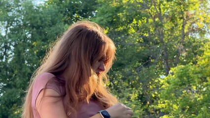 Young woman suffering from mosquito bites in the forest
