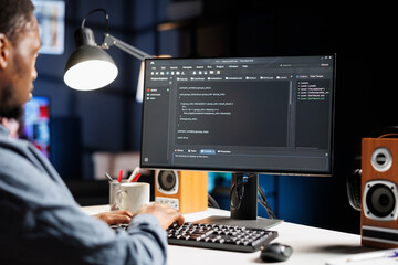 IT specialist writing html script binary code for database security, working on server optimization...