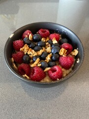Porridge (oatmeal) with blueberries, raspberries, nuts and cinnamon