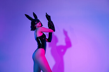 Photo of girl wear black leather rabbit costume gloves feel tempting over neon empty space background