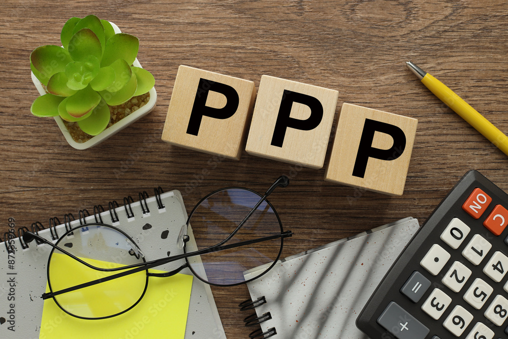Aufkleber bright yellow notepad and calculator near three wooden blocks with text ppp
