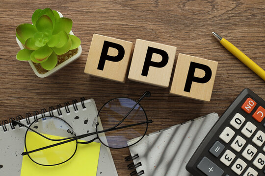 bright yellow notepad and calculator near three wooden blocks with text PPP