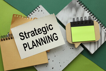 Strategic Planning green background and notepads. text on page