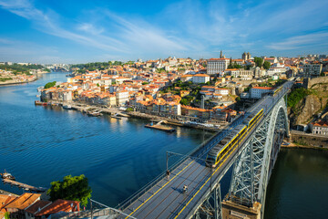 Fototapeta premium View of Porto city and Douro river and Dom Luis bridge I with metro tram from famous tourist viewpoint Miradouro da Serra do Pilar. Porto, Vila Nova de Gaia, Portugal
