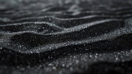 Smooth black sand with delicate light patterns and plenty of room for text 
