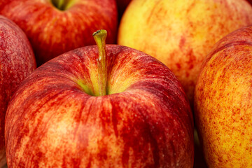Gala apples on a white cutting board.