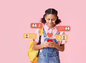 African-American female student with phone on pink background