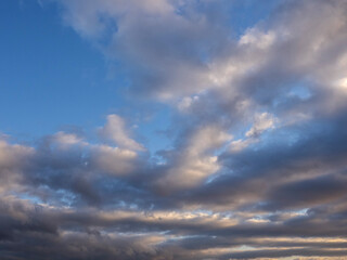 The sky is blue with a few clouds scattered throughout. The clouds are white and fluffy, giving the sky a peaceful and serene appearance. Nature background