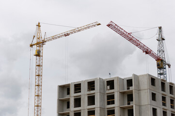 construction crane against the background of an unfinished building