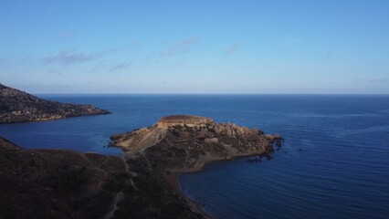 Qarraba Bay flat rock cape Malta, Aerial establishing shot in the morning sunlight. High quality photo