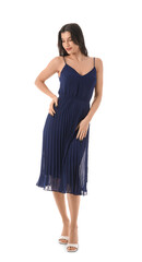 Beautiful young woman in stylish dark blue dress on white background