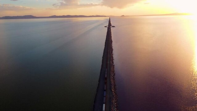 4k Aerial Views of Lucin Cutoff Divide Great Salt Lake Pink Water