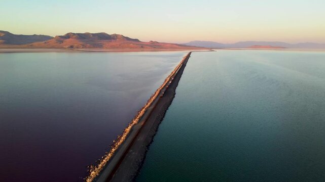 4k Aerial Views of Lucin Cutoff Divide Great Salt Lake Pink Water