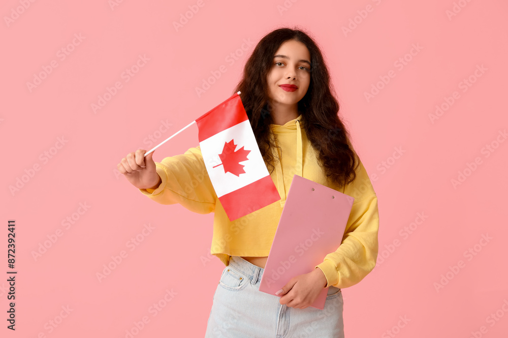 Wall mural female student with flag of canada and clipboard on pink background