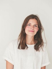 Obraz premium Mock up T-shirt. Portrait of a young girl with long hair on a white background.