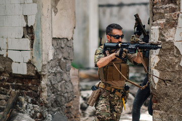 Courageous soldier with weapon in action during rescue operation.