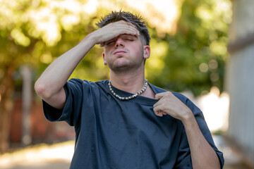 young man or boy with hot expression in summer, heat wave