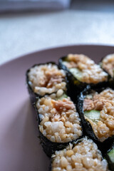 sushi rolls on a pink plate