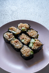 sushi rolls on a pink plate