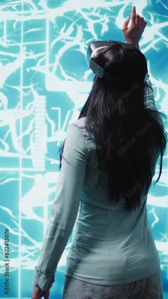 Poster vertical video developer wearing vr headset looking at hologram of artificial intelligence human bra