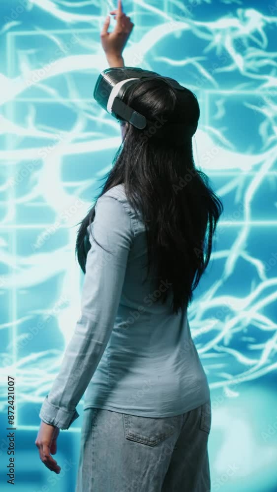 Poster vertical video developer wearing vr headset looking at hologram of artificial intelligence human bra