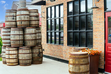 Stack of wooden vintage barrels in front of a pub