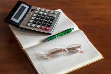 Calculator and pen on sheet, Household expenses concept 