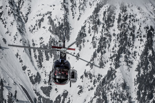 Helicopter in front of snow-covered rock face, Himalaya, Gulmarg, Kashmir, India, Asia
