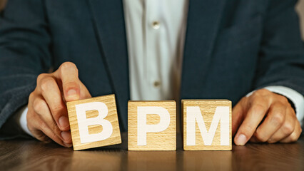 There is wood cube with the word BPM. It is an abbreviation for Business Process Management as eye-catching image.