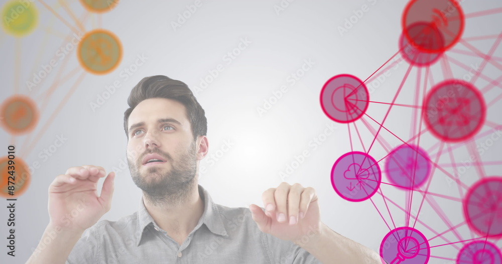 Poster digital composite image of two globe of digital icons spinning over man gesturing against grey backg