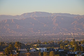 The towering San Gabriel Mountains loom over Los Angeles's San Fernando Valley as the day comes to the end