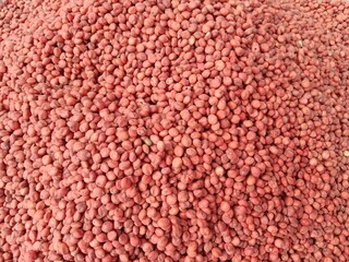 Top view of Hybrid sorghum sudan grass red seeds pile displayed in order on vendor's.Sorghum × drummondii red seeds pile show for sale in the market. Sorghum sudangrass red seeds pattern