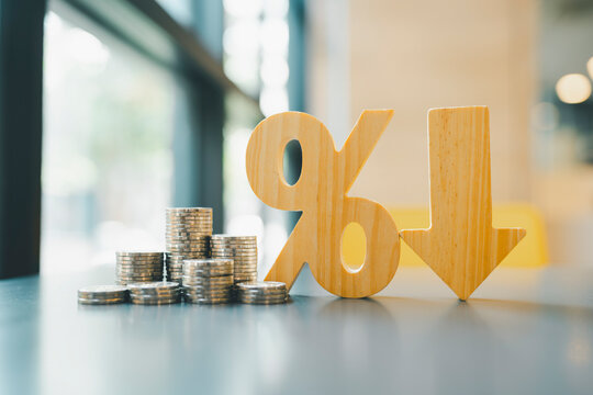 Percentage model, coin stack and down arrow, concepts for success, methods, systems of raising or lowering Fed interest rates to correct inflation concepts.