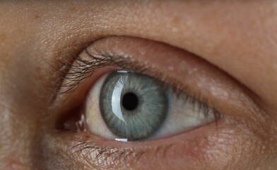 Woman with beautiful blue eyes, macro photo