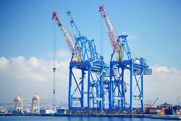Obraz premium Blue Port Cranes in a Sunny Harbor