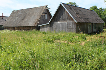 Obraz premium Two traditional wooden farmhouses in Latvia in summer