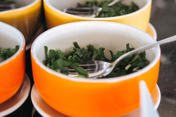 bowl of chopped green onions