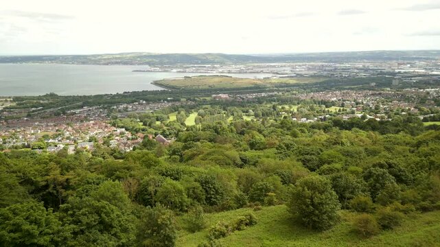 Aerial shot of Belfast from Cavehill mountain in Northern Ireland.

Filmed on a sunny day, the camera passes over fields to reveal the city.

Filmed in 4K, 60 frames per second and in Rec709 colour.