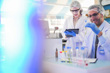 scientists perform experiments and record data. people arranges equipment with test tubes and chemicals for producing medicine and biochemistry. man hold tubes of chemical liquids and plant samples.