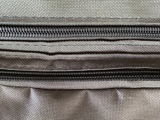close up of a zipper on fabric bag