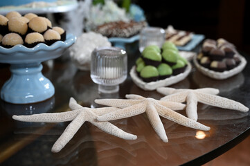 starfish, table decoration, reception table, cake and sweet table, birthday party, sea shells, maritime theme, birthday, party, party decoration, decoration with shells, table decorated with shells
