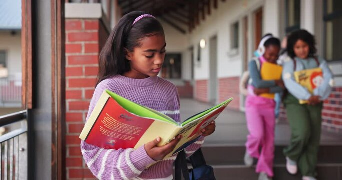 Child, girl and reading book in school for learning, education and development as student in outdoor. Female learner, knowledge and pride for growth, skills and scholarship in literacy or numeracy