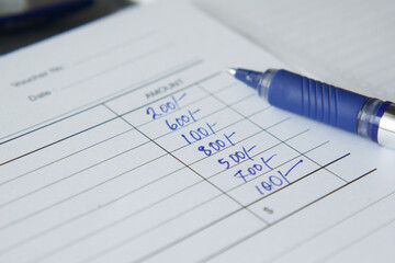  A man writes payment due in a paper form 