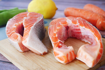 Raw, fresh salmon steak and vegetables on white 